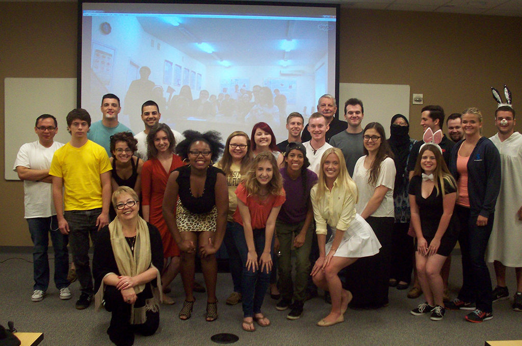 Group of people standing in front of screen
