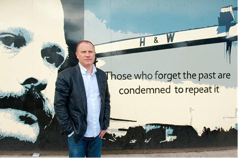 man standing in front of mural