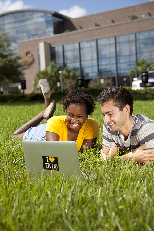 Two students in grass outside Career Services