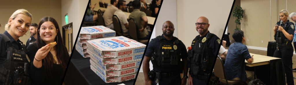 Community event featuring uniformed police officers interacting with attendees. A stack of pizza boxes is displayed on a table. People are seated at tables in a meeting room setting.