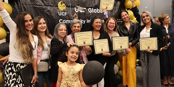 CEP Graduation Community English Program graduating students posing for a picture showing off their certificates
