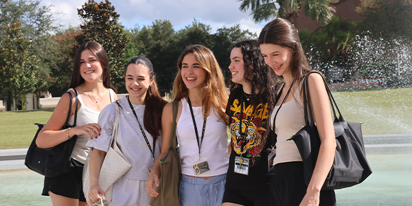 UGL_5116 Students Smiling in Front of UCF Reflection Pond