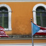 American and Puerto Rican Flags flying in front of building in SAN JUAN, PUERTO RICO